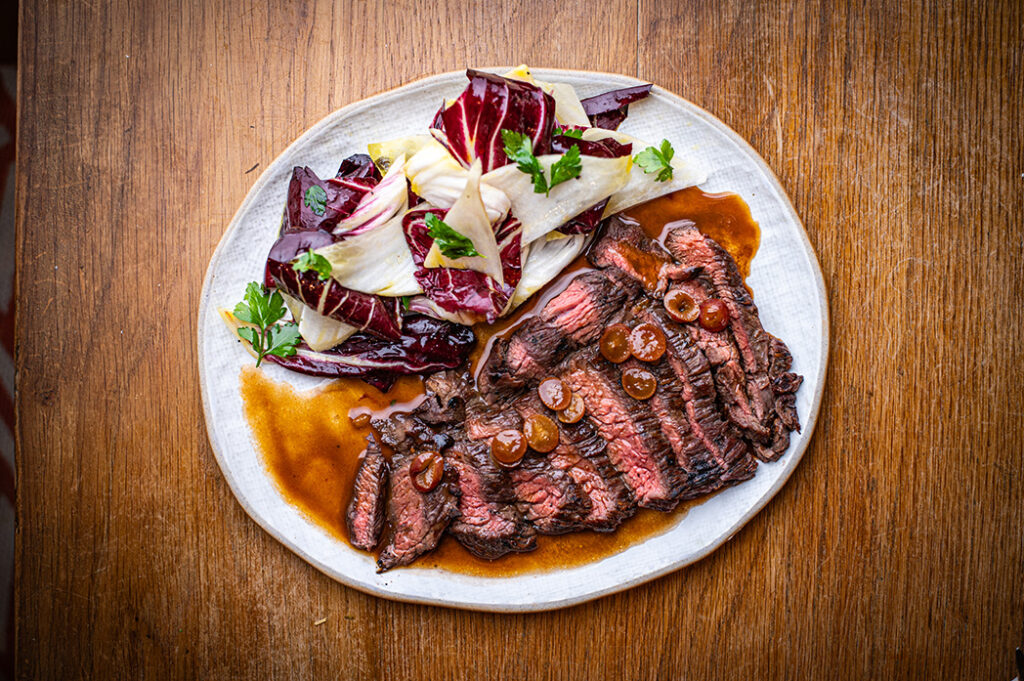Sliced flat iron steak with pickled grapes and a radicchio salad at The Granary