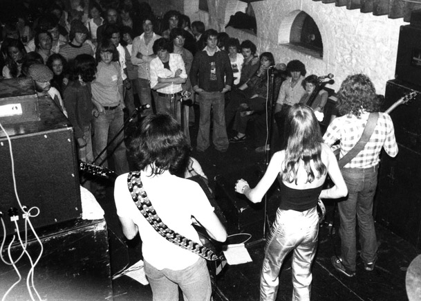 Stargazer playing to a packed crowd at The Granary Club around 1978, seen from behind the band on stage, in a black-and-white photo