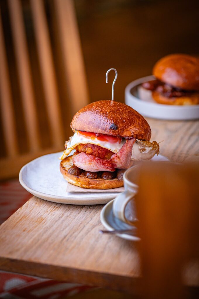 The Breakfast Stack of fried egg, merguez sausage, bacon and Maakouda potato cake in a toasted bun at The Granary